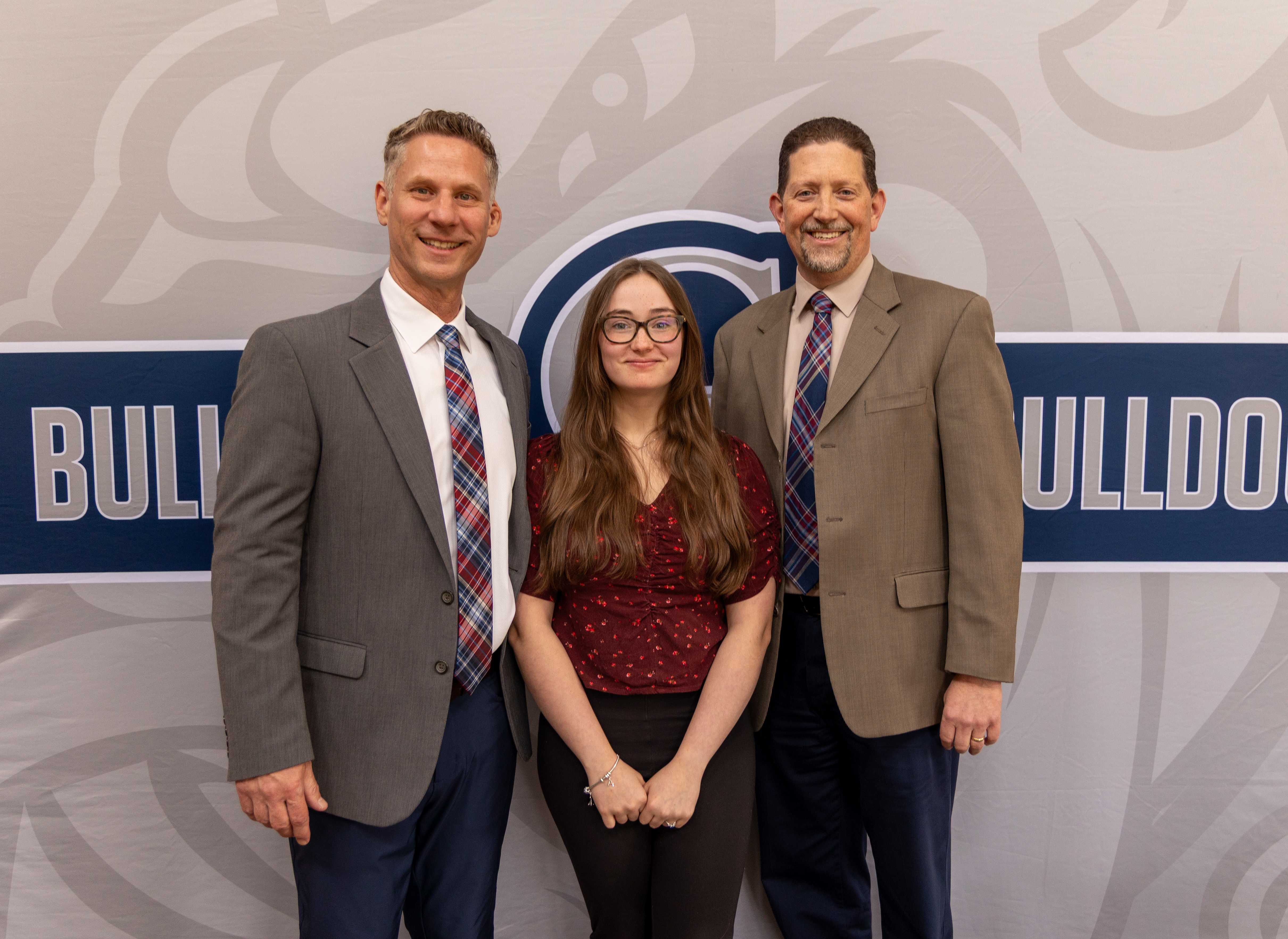 Abigail Smith poses with Principal Barr and Superintendent Sickles